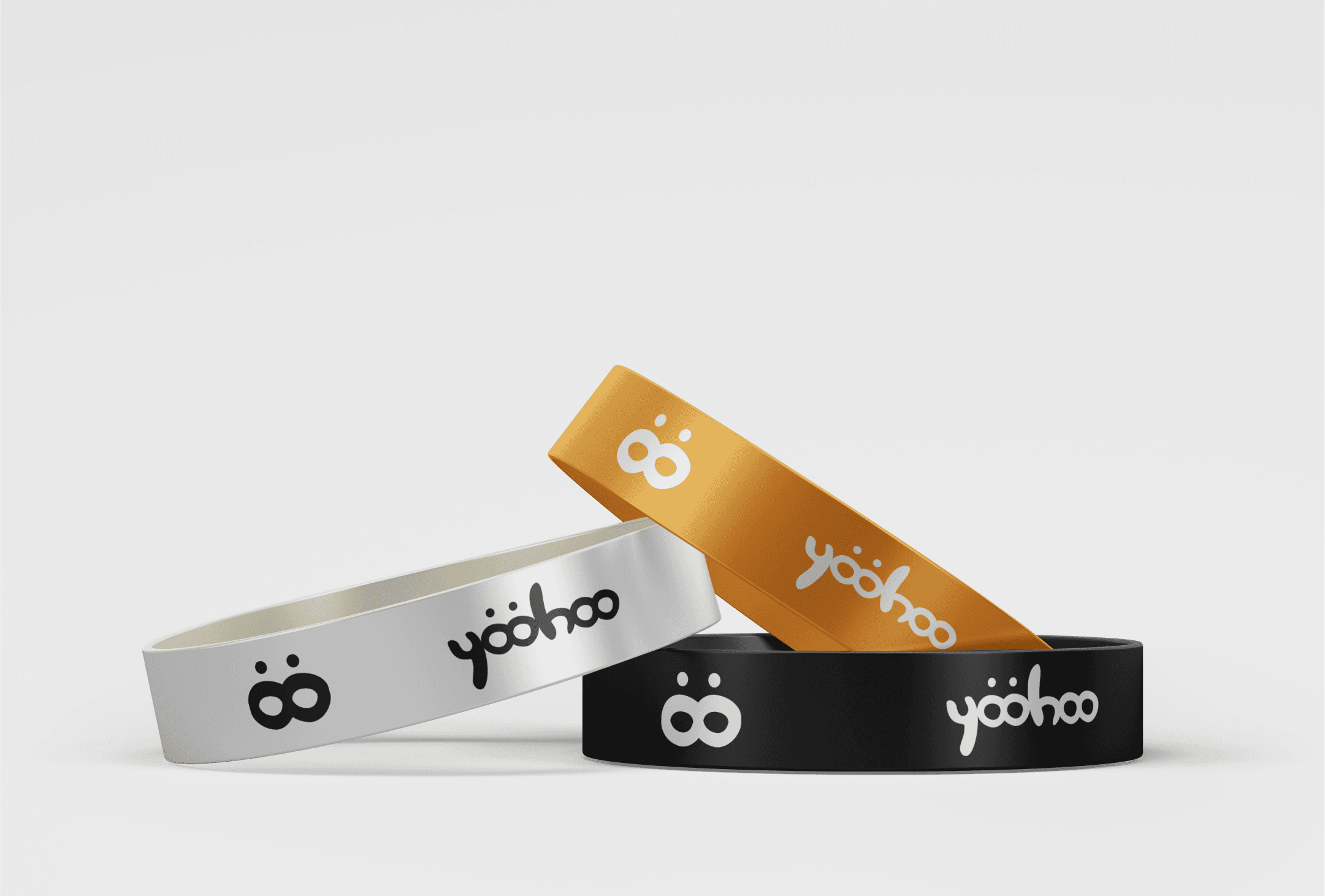 Silicone wristbands in white, orange and black with the YooHoo mark and wordmark